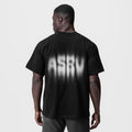 Tech Essential Relaxed Tee in black with motion blur graphic, worn by model, back view