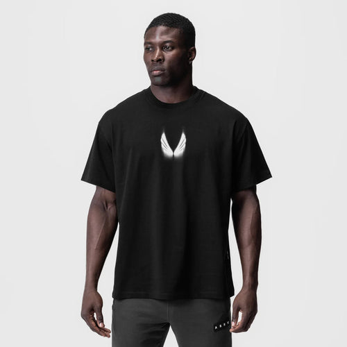 Black Tech Essential Relaxed Tee with white wing logo, worn by model, front view