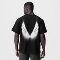 Black Tech Essential Relaxed Tee with white graphic design, back view on model