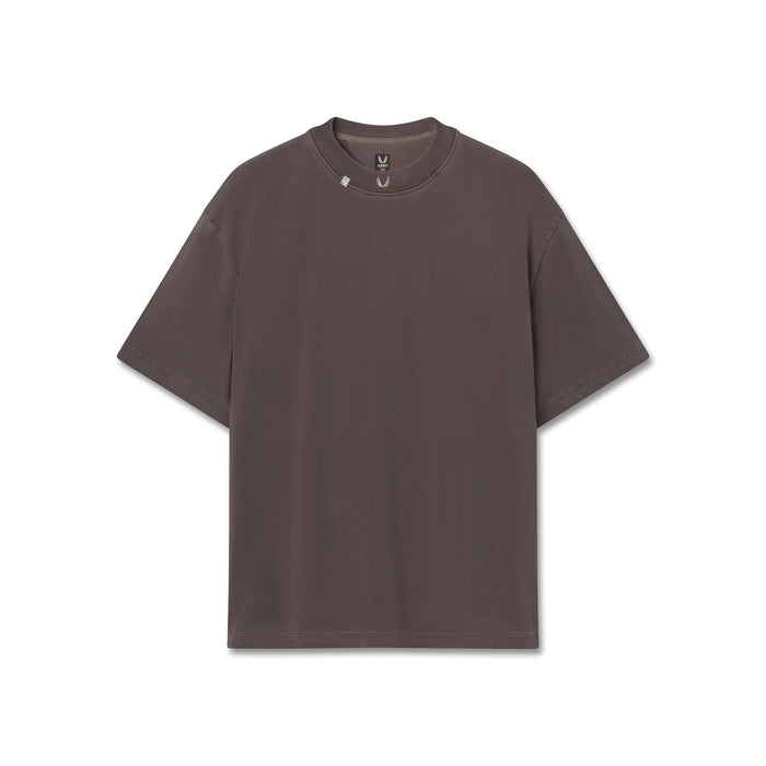 Flatlay of a dark brown short-sleeve crewneck t-shirt with small embroidered wings logo on the collar, displayed flat against a solid white background.