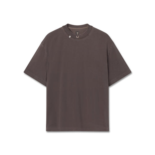 Flatlay of a dark brown short-sleeve crewneck t-shirt with small embroidered wings logo on the collar, displayed flat against a solid white background.