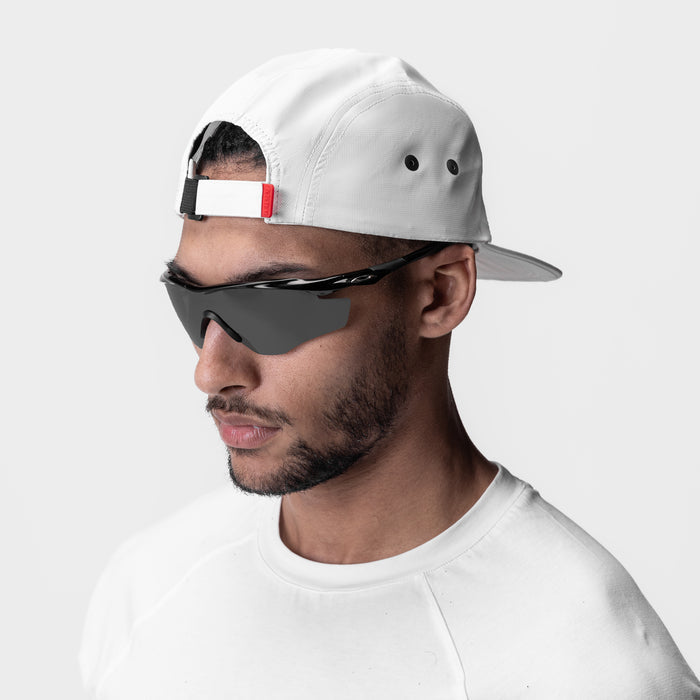 White 5-Panel Run Cap worn by model with sunglasses, side profile view