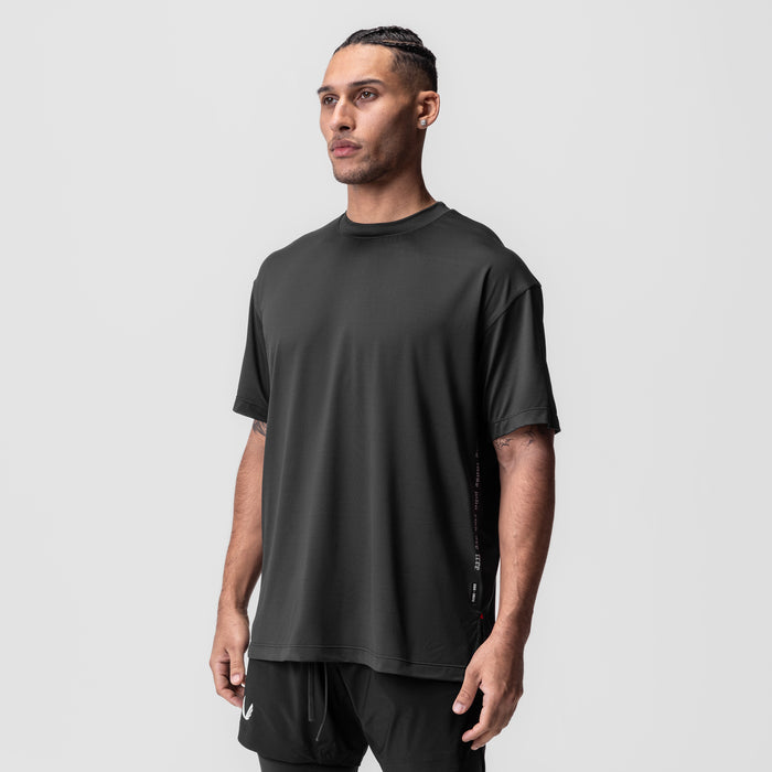 AeroSilver Oversized Tee in black worn by model, three-quarter front view
