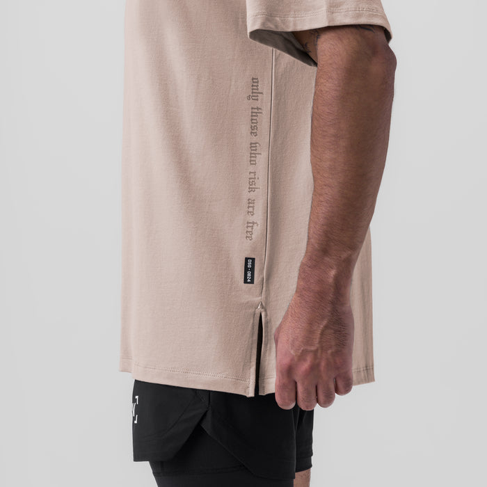 Supima Oversized Tee in Chai worn by model, side view showing text detail