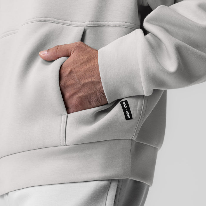 Dri-Core Oversized Crewneck in light grey, worn with hand in kangaroo pocket