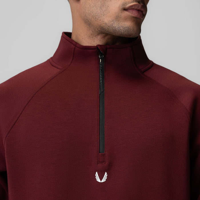 Dri-Core Quarter Zip in crimson, worn by model, front closeup view showing logo