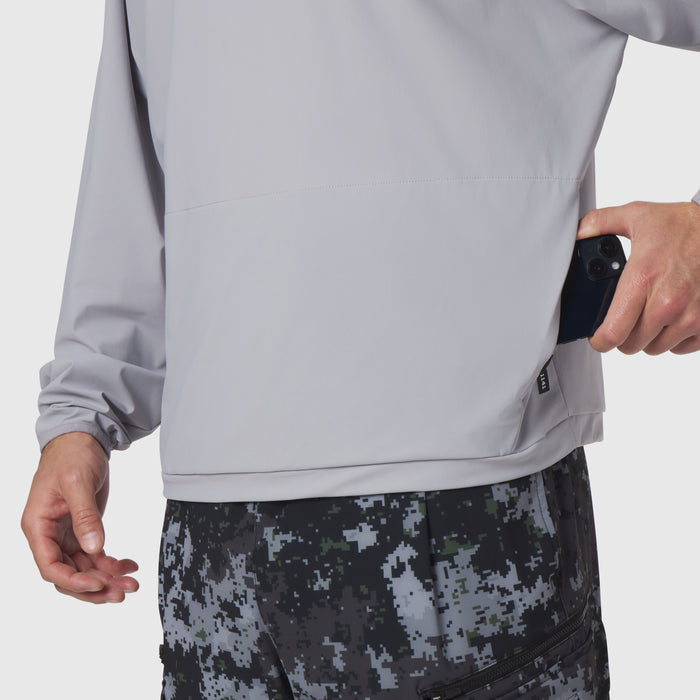 Tetra-Lite Blade Collar Zip Jacket in slate grey, worn by model holding phone