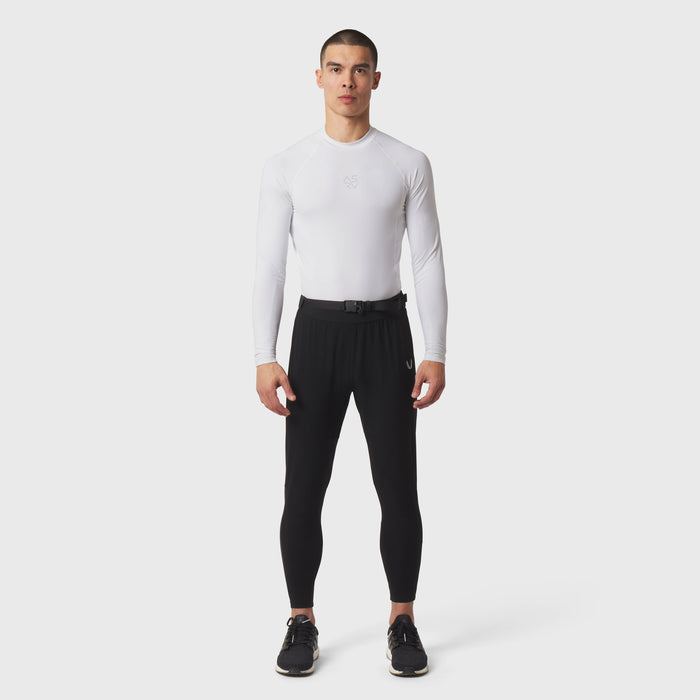 White LYCRA® ADAPTIV Baselayer Longsleeve worn with black leggings, front view