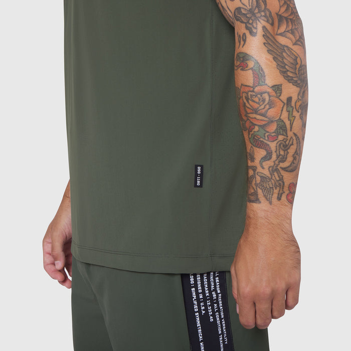 Laser-Vent Training Tee in olive worn by model showing side view with tattoo visible