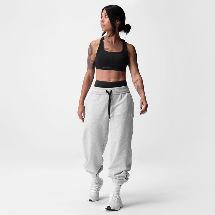 Black Lycra® Hybrid Sports Bra worn with grey joggers, front view on model