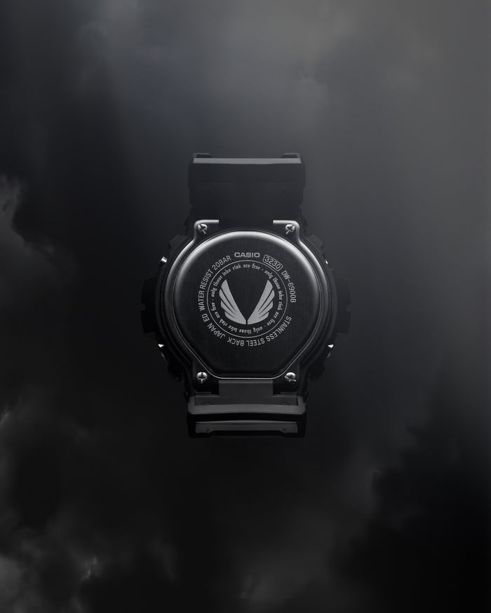 ASRV x G-SHOCK DW6900 digital watch in black, back view on dark background