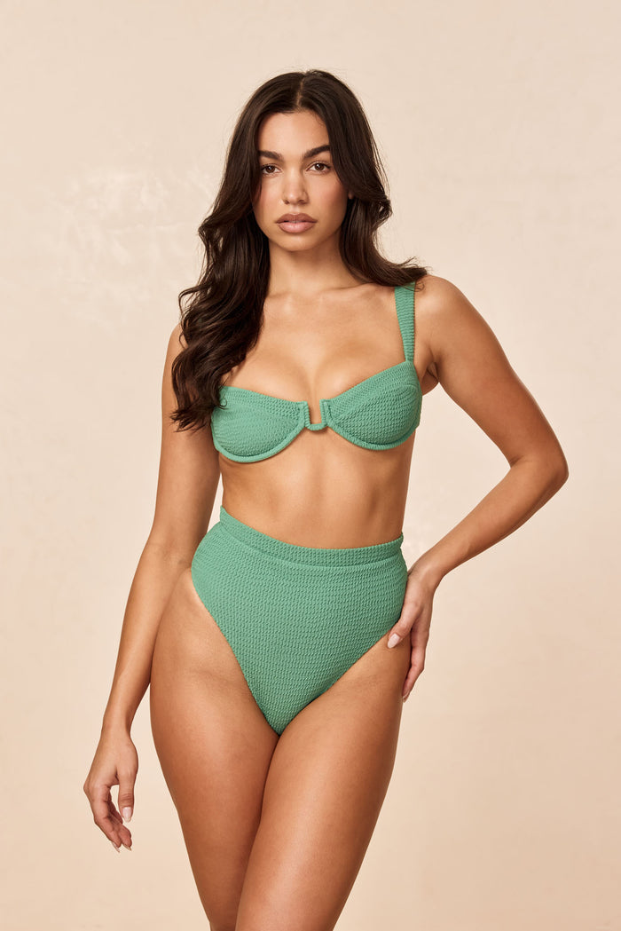 Front view of Cala Roja Top in Pond Crinkle green on model, underwire balconette and matching high‑waist bottoms