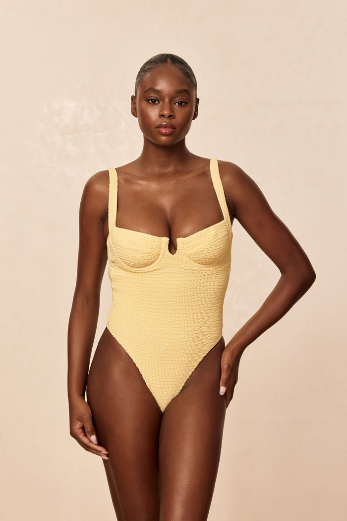 Front view of Clovelly one-piece swimsuit in honey crinkle on model with underwire sweetheart neckline and high-cut leg