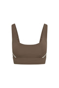 Front view of Denali The Devin Bra in stone with ivory side accents, scoop neckline and wide underband on white background