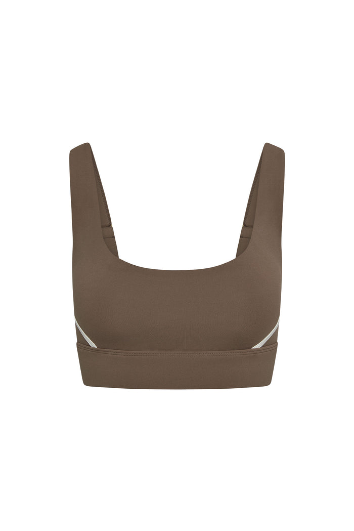 Front view of Denali The Devin Bra in stone with ivory side accents, scoop neckline and wide underband on white background