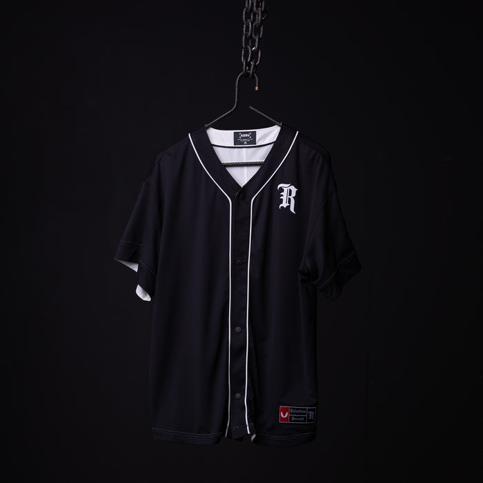 FA'21 Reversible Jersey in black with white piping, displayed on hanger against dark background