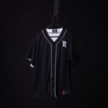 FA'21 Reversible Jersey in black with white piping, displayed on hanger against dark background