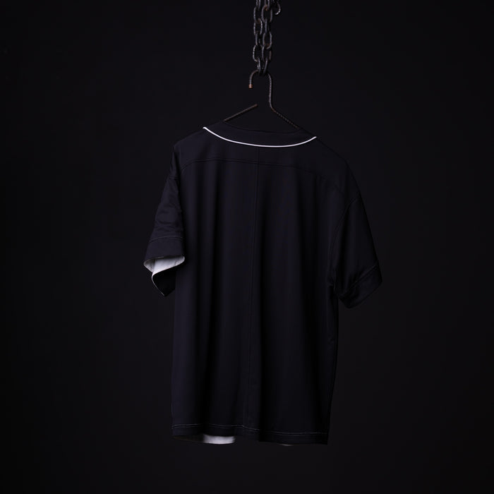 FA'21 Reversible Jersey in black, displayed on hanger against dark background, back view