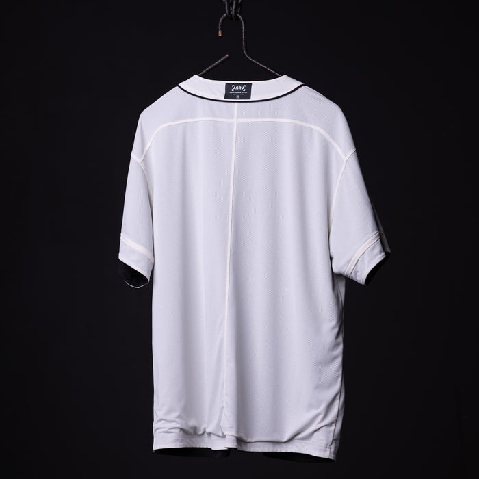 FA'21 Reversible Jersey in white, displayed on hanger against black background, back view