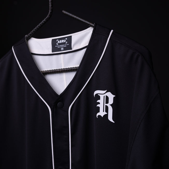 FA'21 Reversible Jersey in black with white piping on hanger, front view