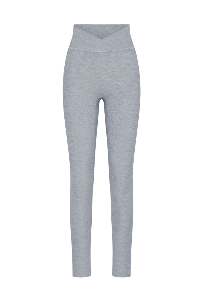 Heather gray high-waist leggings with crossover V waistband, full-length slim-fit legs and heathered knit texture.