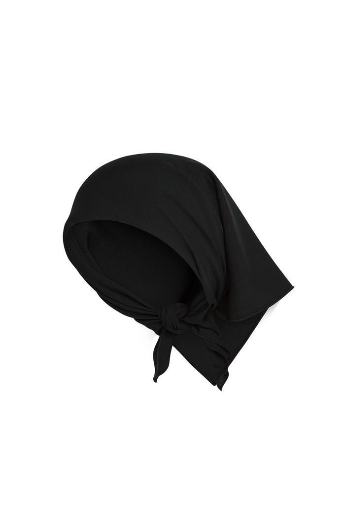 Angled flat view of Monday Headscarf in black showcasing tied corner knot and soft rayon drape on white background