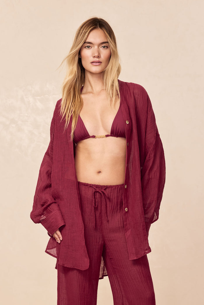 Front view of Monday Top in Fig showcasing triangle cups with gold center hardware on a model against a beige background