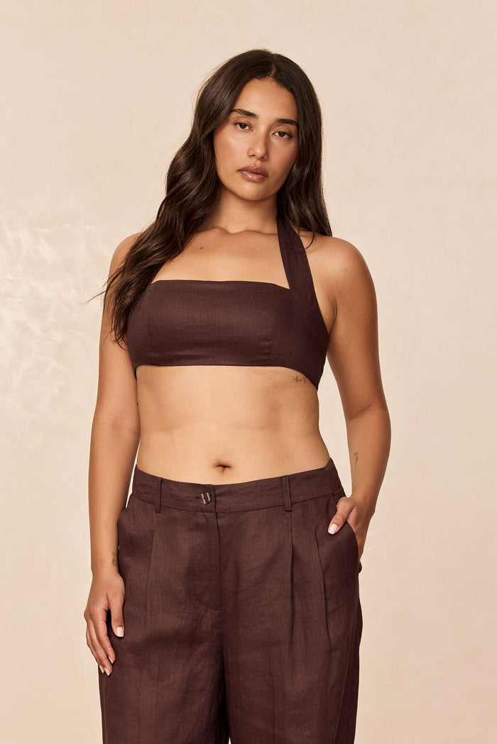 Front view of Montserrat Top in espresso linen on model, square bandeau with halter strap, beige studio background