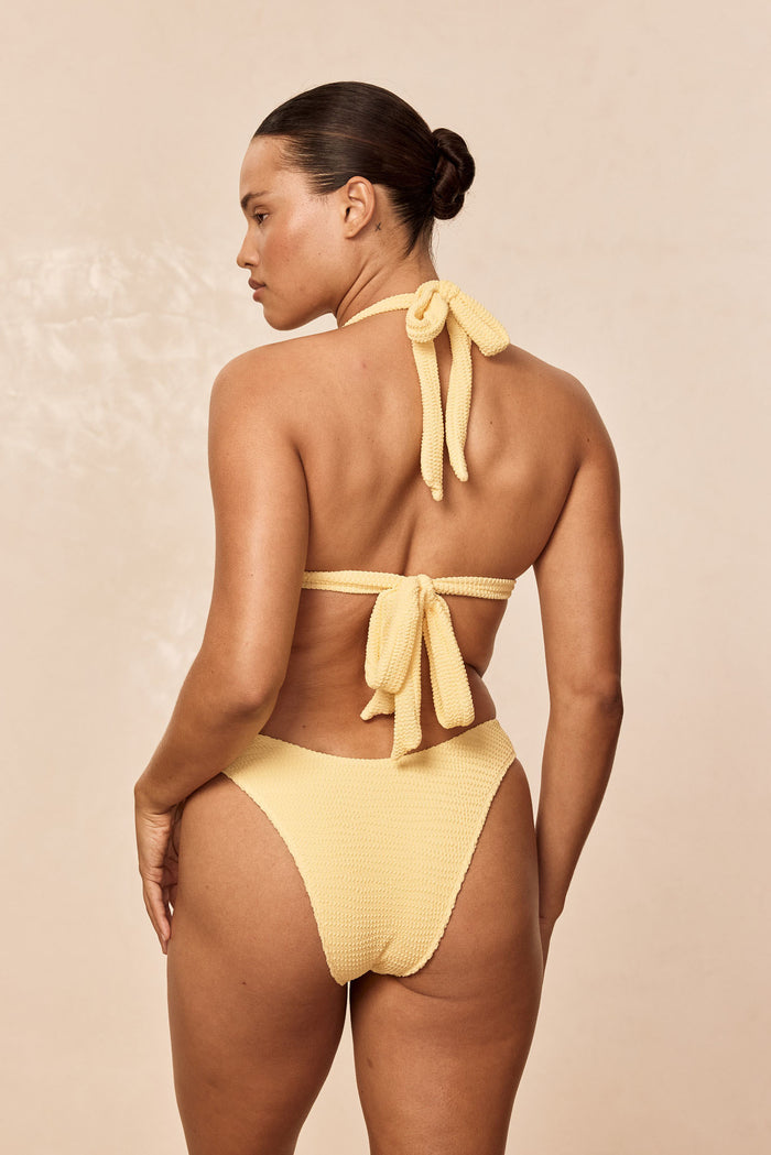 Rear view of Morocco Top in Honey Crinkle on model showing halter neck and back-tie details and textured crinkle fabric