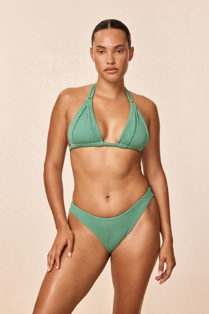 Front view of Morocco Top in Pond Crinkle green textured halter triangle bikini on model, showing V-neck and adjustable ties