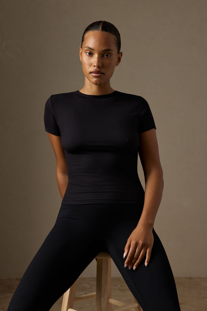 Front view of Ojai Tee Long in Black Lightweight Rib on a model, showing crew neck, short sleeves and fitted ribbed fabric against a neutral studio background