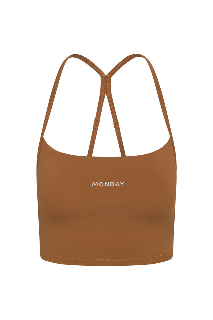Front view of Olympic Tank in Caramel showing adjustable racerback straps, shelf bra and MONDAY embroidery on white background
