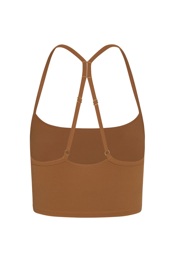 Back view of Olympic Tank in caramel showcasing adjustable racerback straps and built in shelf bra on white background
