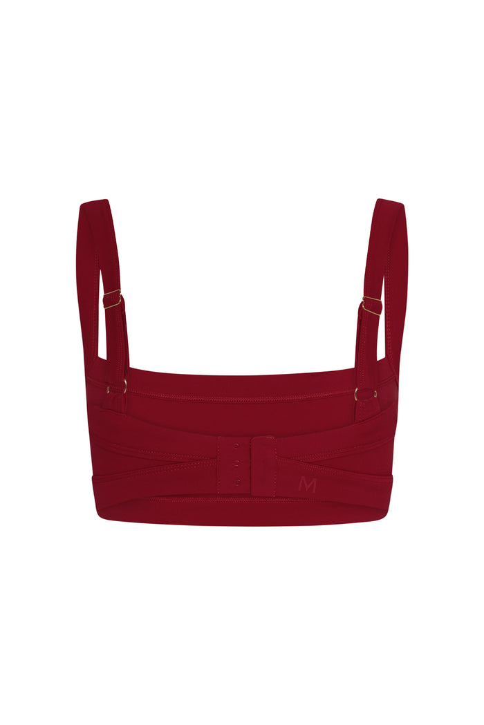 Rear view of Outpost Bra in Cherry showcasing adjustable straps and three-hook back closure on white background