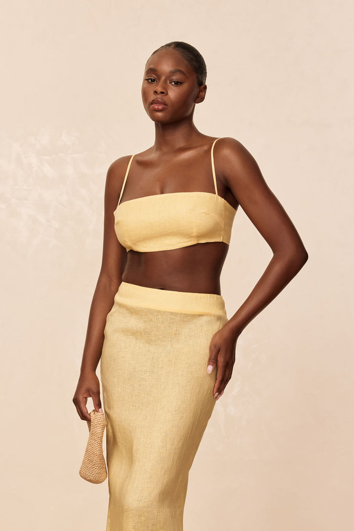 Front view of San Diego Top in Honey showcasing cropped linen bandeau style with thin adjustable straps on beige background