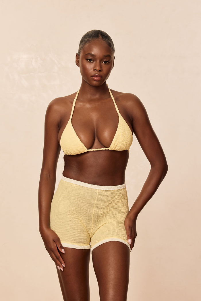 Front view of Palma Top in Honey Crinkle on model, triangle halter top with adjustable ties and gold hardware