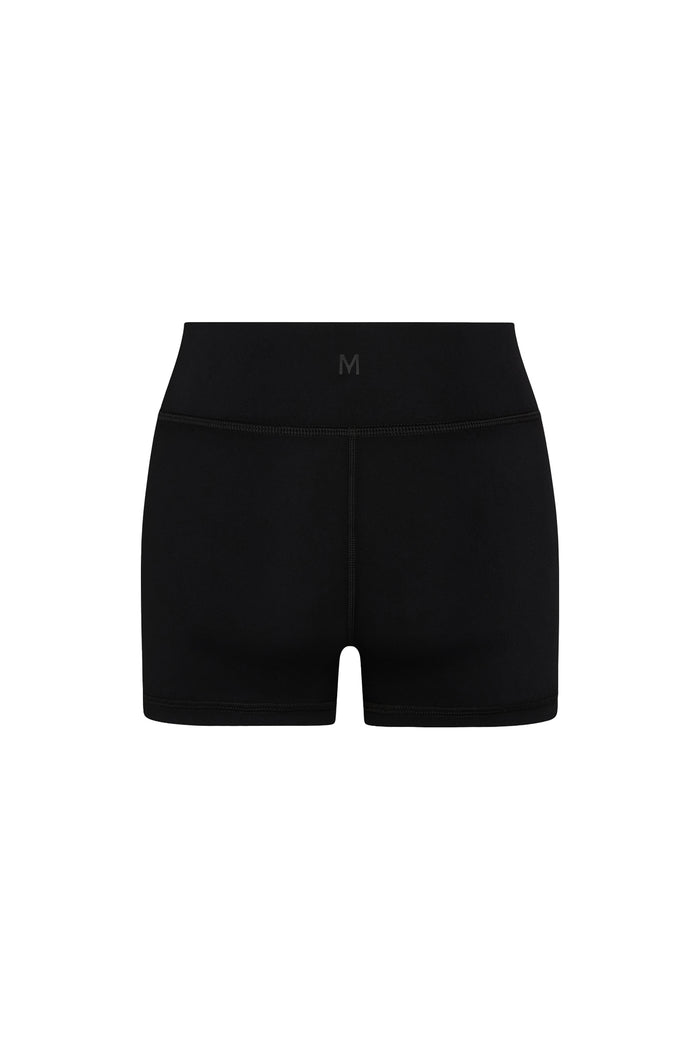Rear view of Sedona Short in black showing doubled waistband, center back M logo and 3 3/8 inch inseam on white background