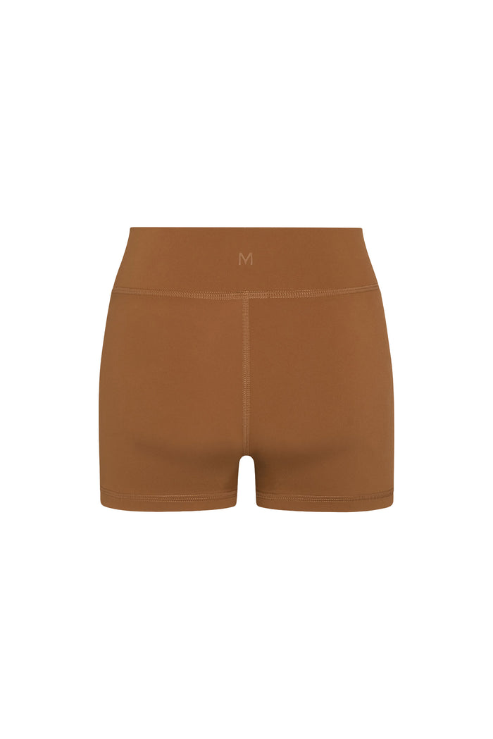 Back view of Sedona Short in Caramel showcasing doubled low-rise waistband, center back seam and booty-short fit on neutral background