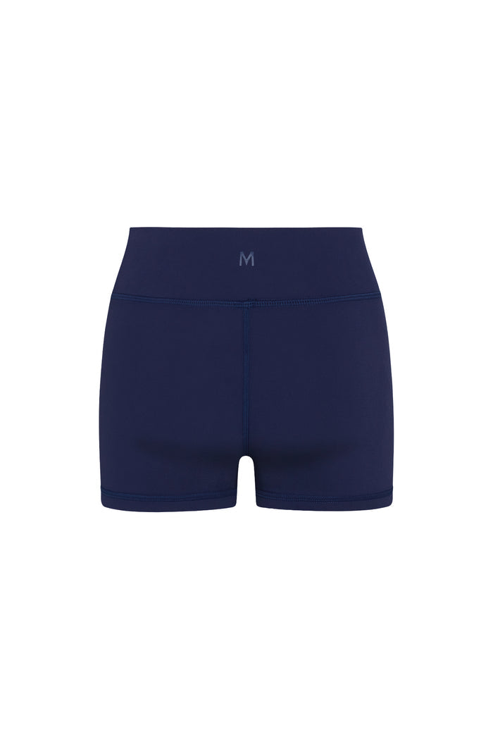 Rear view of Sedona Short in Midnight showcasing low-rise doubled waistband and center back seam on white background