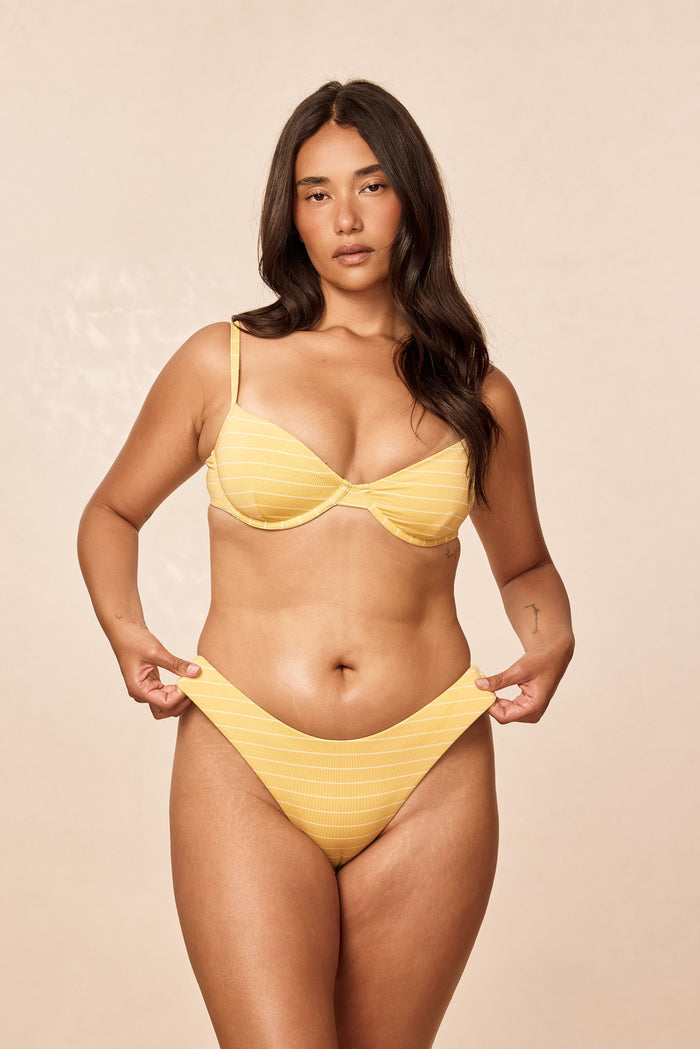 Front view of Seychelles Bottom Meyer Stripe on model showing mid-rise moderate coverage and yellow stripes on beige background