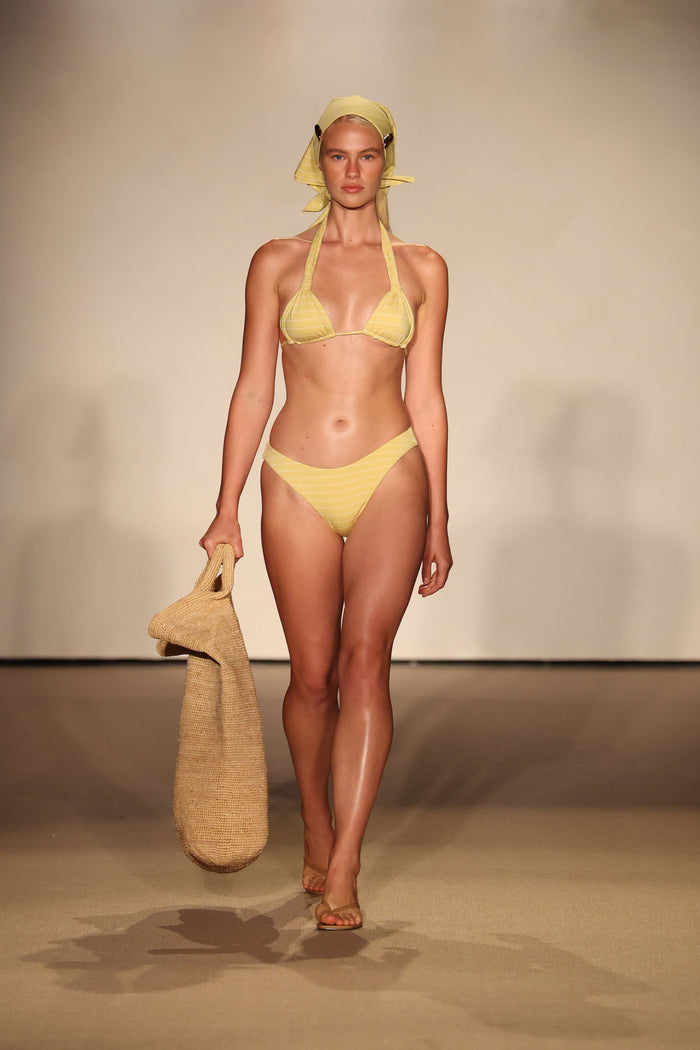 Front view of Seychelles Bottom - Meyer Stripe showcasing mid-rise, moderate coverage on model with beige runway background
