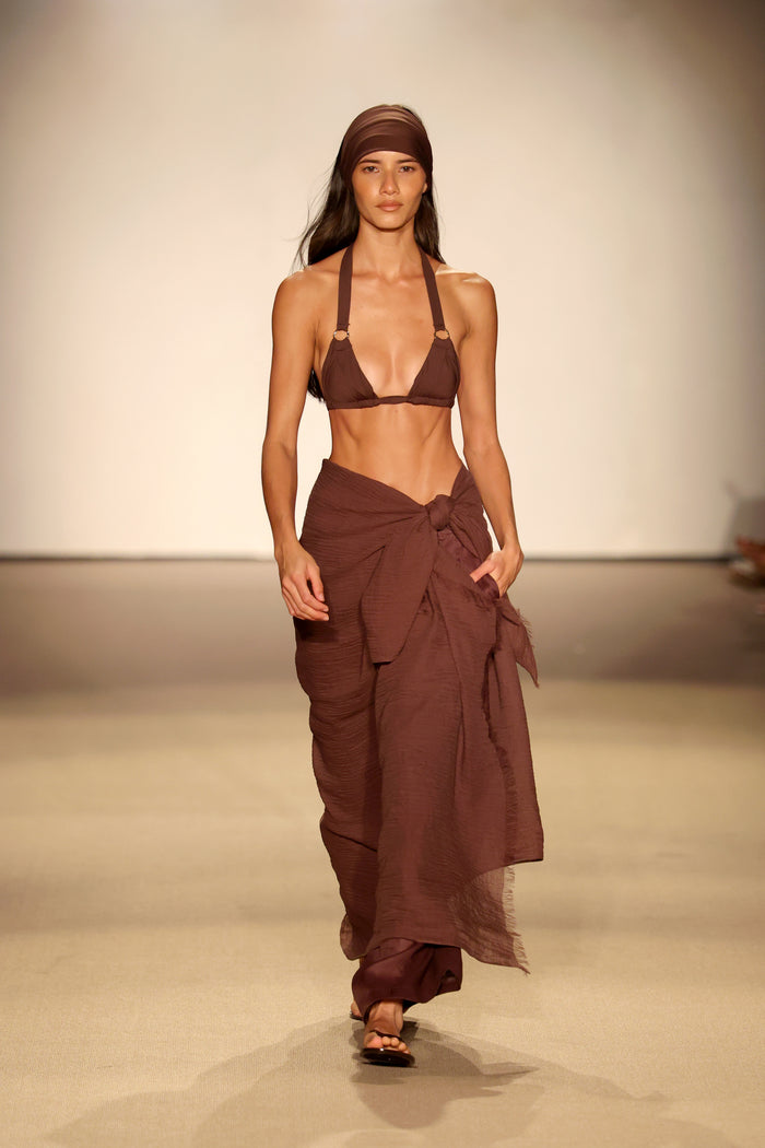 Front view of Bari Top in Espresso on model showcasing pleated triangle cups, gold rings, and halter ties on runway