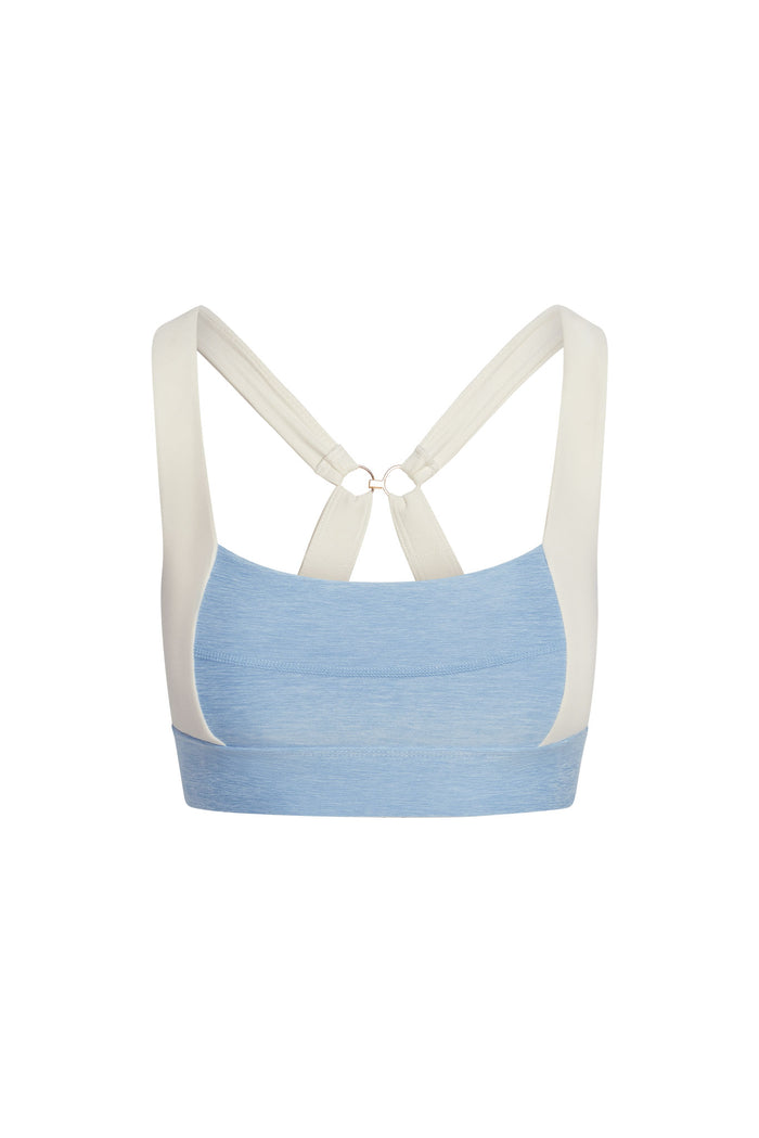 Back view of Tash Bra heather sky/ivory showing crossed adjustable straps with ring and elastic underband on white