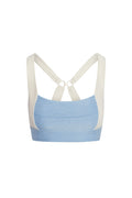 Back view of Tash Bra heather sky/ivory showing crossed adjustable straps with ring and elastic underband on white
