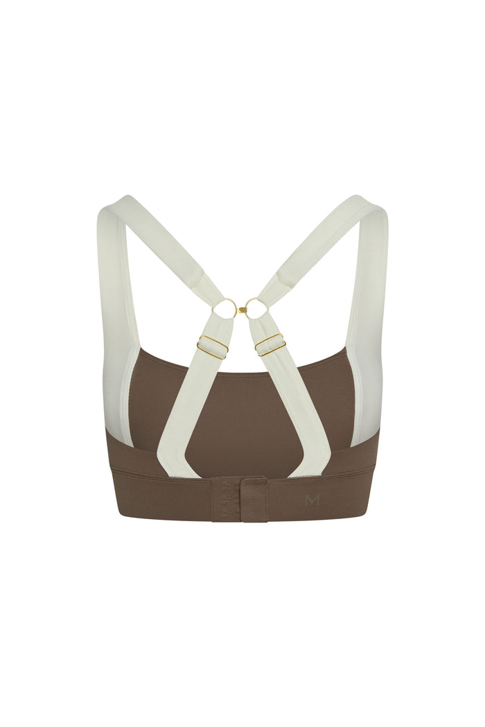 Back view of Tash Bra in stone and ivory jersey with adjustable crossed straps, gold rings, and hook-and-eye back closure