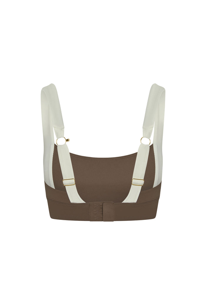 Back view of Tash Bra in stone and ivory showing adjustable straps with gold hardware and hook-and-eye closure on white