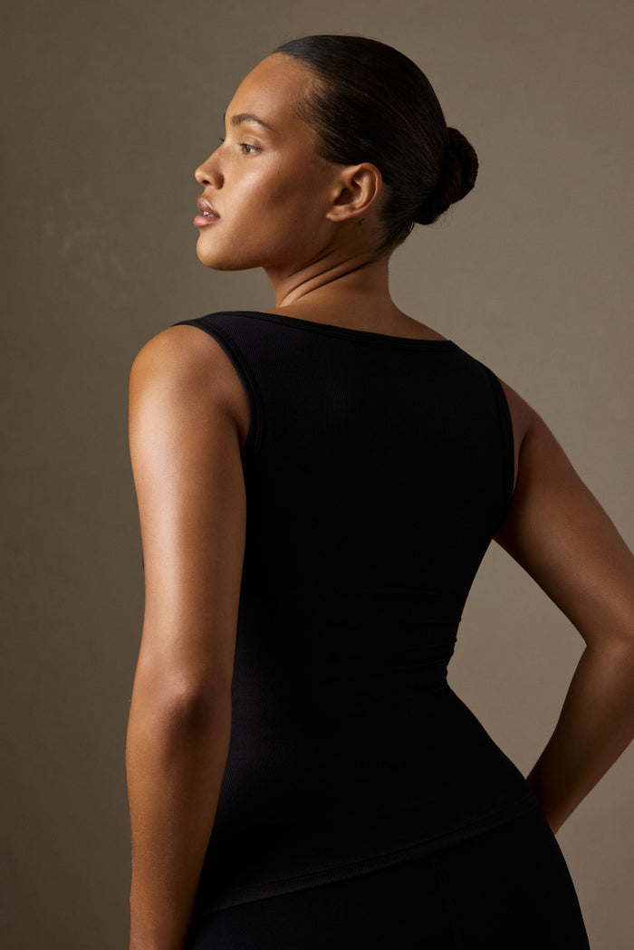 Rear three-quarter view of Tash Tank Long in Black Lightweight Rib showing wide square neckline and ribbed texture