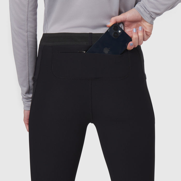 Black Lycra ribbed running tight worn by model, demonstrating phone pocket detail
