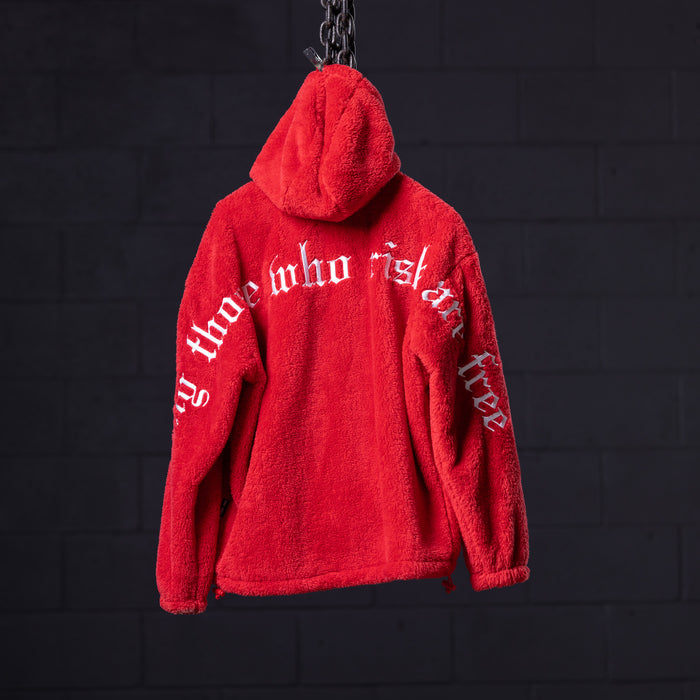 WN '23 Sherpa Recovery Hoodie in red, displayed on chain against dark background, back view