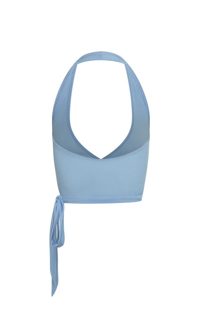 Back view of Yosemite sleeveless top in sky rib, showing deep scoop halter back, ribbed texture and side tie on white